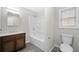 Cozy bathroom features tub and shower combo, wood cabinet vanity, and natural light from a window at 5955 Kemp Dr, Acworth, GA 30102