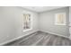 This bedroom features gray wood-look floors, white trim, fresh paint, and natural light at 5955 Kemp Dr, Acworth, GA 30102