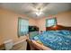 Bedroom with hardwood floors, ceiling fan, and two windows at 5955 Kemp Dr, Acworth, GA 30102