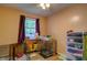 A functional bedroom with natural light and pet kennels at 5955 Kemp Dr, Acworth, GA 30102