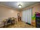 Cozy dining area featuring a wooden table set, patterned curtains, and vintage light fixture at 5955 Kemp Dr, Acworth, GA 30102