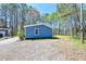 View of blue exterior on a sunny day with gravel driveway at 5955 Kemp Dr, Acworth, GA 30102