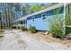 Close up on the blue home's exterior with a porch and small landscaping at 5955 Kemp Dr, Acworth, GA 30102