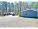Home with an expansive gravel driveway surrounded by mature trees at 5955 Kemp Dr, Acworth, GA 30102