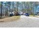Ranch home with brick accents and a gravel driveway with a blue truck at 5955 Kemp Dr, Acworth, GA 30102