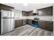 Modern kitchen with stainless steel appliances and stylish gray cabinets and countertops at 5955 Kemp Dr, Acworth, GA 30102