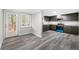 Modern kitchen featuring gray wood-look floors, cabinets, and stainless steel appliances at 5955 Kemp Dr, Acworth, GA 30102