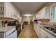 Kitchen featuring white cabinets, granite countertops, and an open layout leading to the dining area at 5955 Kemp Dr, Acworth, GA 30102