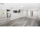 Open-concept living space with kitchen, showcasing stainless appliances and wood floors at 5955 Kemp Dr, Acworth, GA 30102