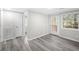 Bright living room featuring sleek gray wood floors and a glass door leading to an outdoor space at 5955 Kemp Dr, Acworth, GA 30102