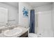 Clean bathroom featuring a granite vanity, and a shower with decorative blue shower curtain at 89 Cowpen Ct, Covington, GA 30014