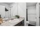 Neutral bathroom boasts a granite countertop with a white basin sink, a decorative mirror, and a shower/tub combo at 89 Cowpen Ct, Covington, GA 30014