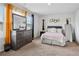 Bedroom featuring a large dresser, multiple mirrors, and bed with a soft pink comforter at 89 Cowpen Ct, Covington, GA 30014