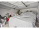 Spacious two car garage interior with covered car and lots of storage space for tools and household items at 89 Cowpen Ct, Covington, GA 30014