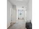 Bright hallway with neutral paint and carpeted floors, showcasing natural light and access to rooms at 89 Cowpen Ct, Covington, GA 30014