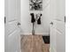 Hallway view showing wood flooring and contemporary decor, leading to various rooms at 89 Cowpen Ct, Covington, GA 30014