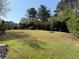 A lush backyard with mature trees and a well-maintained lawn at 9450 Knollcrest Blvd, Alpharetta, GA 30022