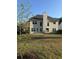 Expansive backyard featuring a well-maintained lawn and the rear elevation of the home at 9450 Knollcrest Blvd, Alpharetta, GA 30022