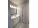 Bathroom featuring a modern vanity with a marble countertop and white cabinets at 9450 Knollcrest Blvd, Alpharetta, GA 30022