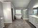 Bathroom featuring a glass enclosed shower, a soaking tub and double vanity at 9450 Knollcrest Blvd, Alpharetta, GA 30022