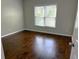 Cozy bedroom with hardwood floors and a large window bringing in light at 9450 Knollcrest Blvd, Alpharetta, GA 30022
