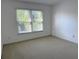 Bedroom showcasing a bright and airy atmosphere with a large window at 9450 Knollcrest Blvd, Alpharetta, GA 30022