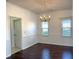 Elegant dining room featuring rich hardwood floors and a sophisticated gold chandelier at 9450 Knollcrest Blvd, Alpharetta, GA 30022