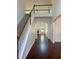 Bright foyer with gleaming hardwood floors, staircase, and arched doorways at 9450 Knollcrest Blvd, Alpharetta, GA 30022