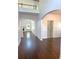 Spacious home foyer with hardwood floors and arched entries to other rooms at 9450 Knollcrest Blvd, Alpharetta, GA 30022