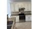 Well-appointed kitchen with cream-colored cabinets, granite countertops, and stainless steel appliances at 9450 Knollcrest Blvd, Alpharetta, GA 30022