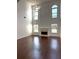 Spacious living room with a soaring ceiling, fireplace, and large windows at 9450 Knollcrest Blvd, Alpharetta, GA 30022