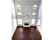 Striking aerial view of a two-story living room with expansive windows, a fireplace, and hardwood floors at 9450 Knollcrest Blvd, Alpharetta, GA 30022
