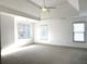 Airy main bedroom with tray ceilings, neutral carpeting, and natural light at 9450 Knollcrest Blvd, Alpharetta, GA 30022