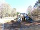 Community playground with multiple slides and a bench for parents to watch their children play at 9450 Knollcrest Blvd, Alpharetta, GA 30022