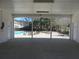 Community pool shelter offers shaded seating with tables and chairs, and leads to an outdoor swimming pool at 9450 Knollcrest Blvd, Alpharetta, GA 30022