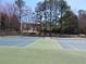 Community tennis courts with mature trees surrounding and black fence for residences enjoyment at 9450 Knollcrest Blvd, Alpharetta, GA 30022