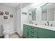 Bright bathroom with mint green vanity, marble countertops, and dual mirrors at 4307 Orchard Park Ct # A, Stone Mountain, GA 30083