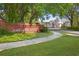 Picturesque entrance to Orchard Park with brick signage and mature trees lining the drive at 4307 Orchard Park Ct # A, Stone Mountain, GA 30083