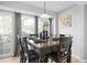 Bright dining room with large windows and a dark wood dining table set for six at 4307 Orchard Park Ct # A, Stone Mountain, GA 30083