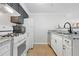 Clean kitchen with white cabinets, granite countertops, and modern gas range oven at 4307 Orchard Park Ct # A, Stone Mountain, GA 30083
