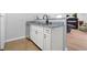 Kitchenette area featuring sink, granite countertop, white cabinets, and modern appliances at 4307 Orchard Park Ct # A, Stone Mountain, GA 30083