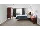Comfortable main bedroom with carpet, decorative side tables, bed and a large window at 4307 Orchard Park Ct # A, Stone Mountain, GA 30083