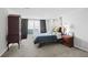 Spacious main bedroom with carpet, decorative side tables, bed and a large window at 4307 Orchard Park Ct # A, Stone Mountain, GA 30083