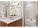 Stylish bathroom with vanity, framed mirror, and tiled shower-tub combo at 791 Wylie Se St # 1111, Atlanta, GA 30316