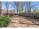 Fenced dog park with wood fencing, gravel terrain, and convenient pet waste station at 791 Wylie Se St # 1111, Atlanta, GA 30316