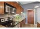 This kitchen features stainless steel appliances, granite counters, and wood cabinets at 791 Wylie Se St # 1111, Atlanta, GA 30316