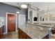 Kitchen with an eat-in granite counter, wood cabinets, and stainless steel appliances at 791 Wylie Se St # 1111, Atlanta, GA 30316