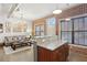 Bright open-concept living space featuring exposed brick, industrial-style lighting, and granite-topped island at 791 Wylie Se St # 1111, Atlanta, GA 30316