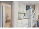 Basement wet bar with white cabinetry and adjacent storage area at 1414 Lynchburg Trce, Grayson, GA 30017