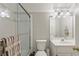 Bathroom featuring a glass shower door, vanity with mirror, and modern white fixtures at 1414 Lynchburg Trce, Grayson, GA 30017